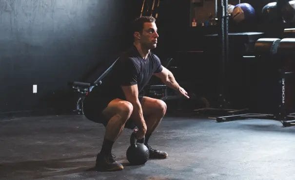 RIse Athletics Man doing a Squat
